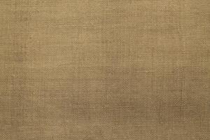 Natural Linen Material Textile Canvas Fabric Texture Background Close-up Detail of Fabric Natural Color Hemp Material Pattern Design Wallpaper. Can be Used as Background or For Graphic Design photo