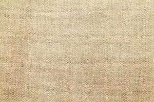 Natural Linen Material Textile Canvas Fabric Texture Background Close-up Detail of Fabric Natural Color Hemp Material Pattern Design Wallpaper. Can be Used as Background or For Graphic Design photo