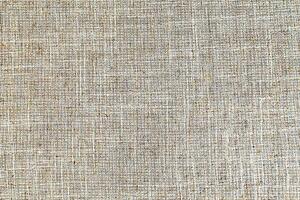 Natural Linen Material Textile Canvas Fabric Texture Background Close-up Detail of Fabric Natural Color Hemp Material Pattern Design Wallpaper. Can be Used as Background or For Graphic Design photo