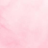 A pink watercolor background with a white background photo