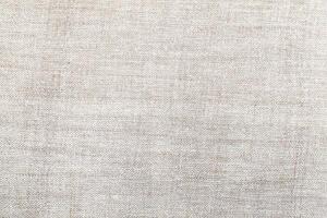 Natural Linen Material Textile Canvas Fabric Texture Background Close-up Detail of Fabric Natural Color Hemp Material Pattern Design Wallpaper. Can be Used as Background or For Graphic Design photo
