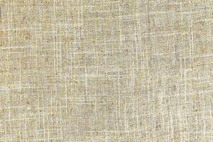 Natural Linen Material Textile Canvas Fabric Texture Background Close-up Detail of Fabric Natural Color Hemp Material Pattern Design Wallpaper. Can be Used as Background or For Graphic Design photo