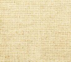 A beige fabric background with a woven pattern photo