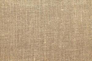 Natural linen material textile canvas Fabric texture background Close-up detail of fabric natural color Hemp material pattern design wallpaper. can be used as background or for graphic design photo