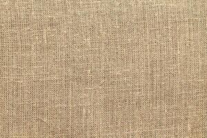 Natural linen material textile canvas Fabric texture background Close-up detail of fabric natural color Hemp material pattern design wallpaper. can be used as background or for graphic design photo