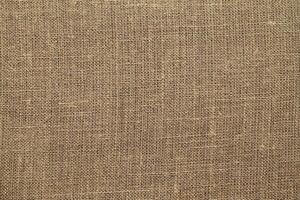 Natural linen material textile canvas Fabric texture background Close-up detail of fabric natural color Hemp material pattern design wallpaper. can be used as background or for graphic design photo