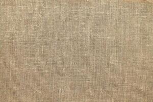 Natural linen material textile canvas Fabric texture background Close-up detail of fabric natural color Hemp material pattern design wallpaper. can be used as background or for graphic design photo