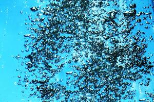 fresh water with underwater bubbles texture on a blue background close-up abstract liquid bubbles aqua design wallpaper photo