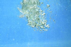 fresh water with underwater bubbles texture on a blue background close-up abstract liquid bubbles aqua design wallpaper photo