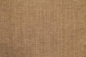 Natural linen material textile canvas Fabric texture background Close-up detail of fabric natural color Hemp material pattern design wallpaper. can be used as background or for graphic design photo