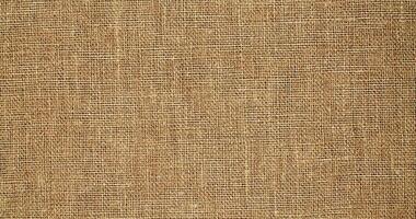 Natural linen material textile canvas Fabric texture background Close-up detail of fabric natural color Hemp material pattern design wallpaper. can be used as background or for graphic design photo