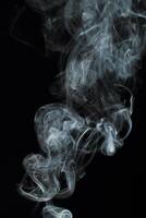 Abstract white smoke texture moves on black background Plume of smoke wave design wallpaper. Design element. Abstract texture photo