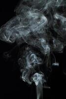 Abstract white smoke texture moves on black background Plume of smoke wave design wallpaper. Design element. Abstract texture photo