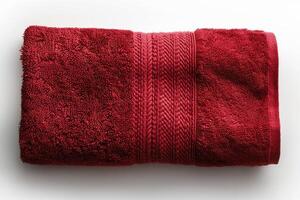 A red bath towel highlighted on a white background. Hand towel made of natural fabrics. Cotton. photo