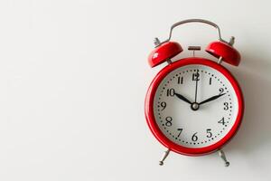 a red and white alarm clock highlighted on a white background. A retro-style watch. The concept of time. photo