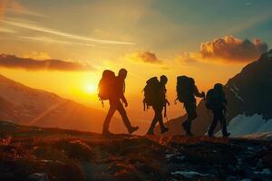 A group of tourists with backpacks walks through the mountains at sunset. The concept of travel, an active lifestyle. photo