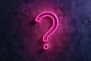 neon glowing question mark on a dark background. A neon sign illuminated in the form of a question mark. photo