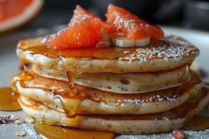 Delicious Stack of Pancakes Topped with Fresh Grapefruit Segments and Drizzled with Honey - Perfect for Breakfast photo
