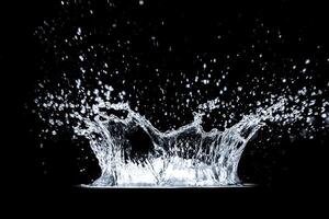 High-Speed Capture of Water Splash Against Black Background with Droplets in Motion photo