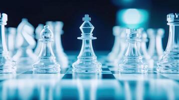 Close-up of glass chess pieces on a chess board with a blue background, highlighting the king in the center. photo