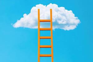 Orange ladder reaching towards a white cloud in a bright blue sky, symbolizing aspiration, goal setting, and success. Minimalist concept. photo
