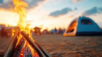 Cozy campfire with a tent in the background during a beautiful sunset, perfect for outdoor adventures and camping enthusiasts. photo