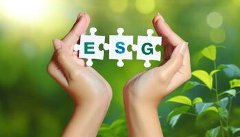 Hands holding puzzle pieces with ESG letters against a green natural background, representing environmental, social, and governance concepts. photo