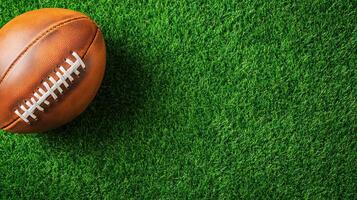 Close-up of an American football resting on green artificial turf. Perfect for sports-related content and football themes. photo