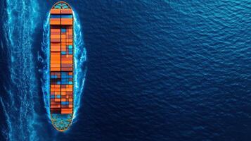 Aerial view of a large cargo ship filled with colorful containers navigating through the blue ocean. photo