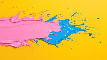 Vibrant splash of pink and blue paint on a bright yellow background, showcasing an artistic and colorful texture. photo