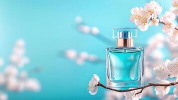 Elegant perfume bottle surrounded by delicate blossoms against a serene blue background, evoking freshness and beauty. photo