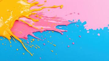 Vibrant paint splash in yellow, pink, and blue on a textured background, perfect for creative and artistic projects. photo