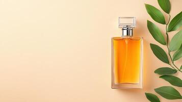 Elegant perfume bottle with orange liquid beside green leaves on a soft beige background, perfect for beauty and fragrance themes. photo