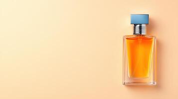 Elegant perfume bottle with orange liquid and blue cap on a soft peach background, perfect for beauty and fragrance themes. photo