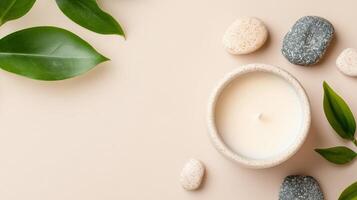 A serene composition featuring a candle surrounded by natural stones and green leaves, perfect for relaxation and wellness. photo