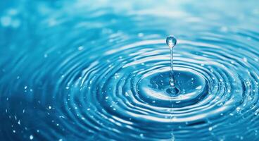 A close-up of a water droplet creating ripples in a serene blue background, capturing the essence of tranquility and freshness. photo