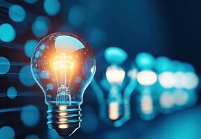 A glowing light bulb illuminating a dark background, representing creativity and inspiration in a modern environment. photo