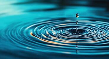 A vivid close-up of a water droplet creating ripples on a serene surface, capturing the beauty of nature's fluid motion. photo