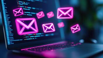 Digital communication concept with glowing email icons above a laptop showing programming code on the screen. photo