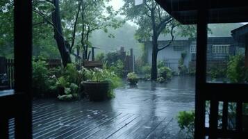 View from a window of a rainy backyard with a wet wooden deck. photo