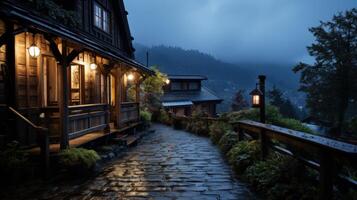 A cobblestone pathway leads up to a wooden cabin in the forest, illuminated by warm light from the windows and porch light.  The air is misty and the sky is a soft blue. photo