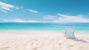 A single white lounger sits on a pristine, white sand beach overlooking a turquoise ocean and a bright blue sky. photo
