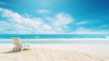 A white wooden chair sits on a sandy beach overlooking a clear blue ocean and a bright sky with white clouds. photo