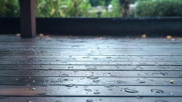 Close-up of rain drops on a wet wooden deck. photo