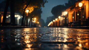 Wet cobblestone street with blurred streetlights and raindrops at night. photo