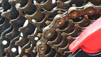 Close-up of a Bicycle Gear Mechanism with Rusty Chain and Red Derailleur photo