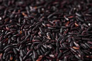 raw fresh black rice on a white background photo