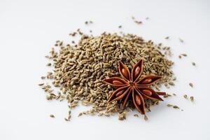 aromatic dry anise seeds on a white background photo