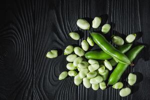 fresh greens broad beans fava on a dark background photo