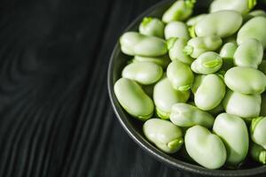 fresh greens broad beans fava on a dark background photo
